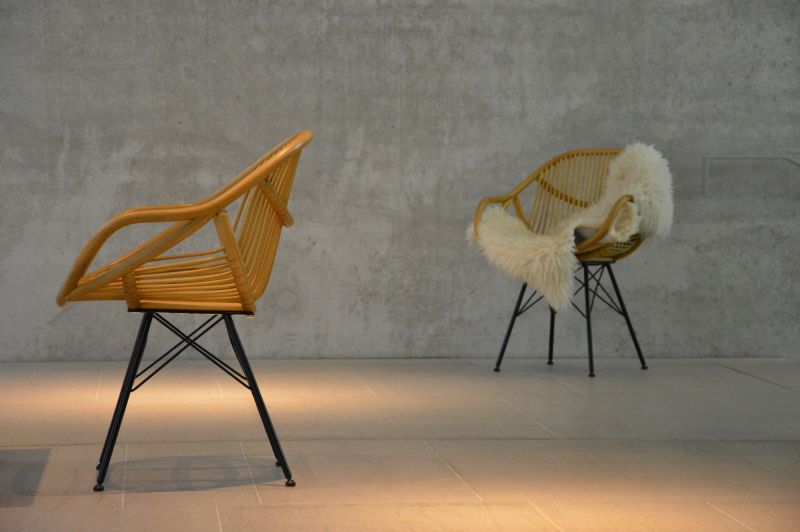 Yara Stuhl von Jan Kurtz, Rattansessel mit schwarzem Metallgestell, einladend und modern.